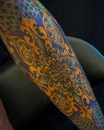 Color mandala lower leg tattoo done by tattoo artist Alan Lott of Sacred Mandala Studio in Durham, NC.